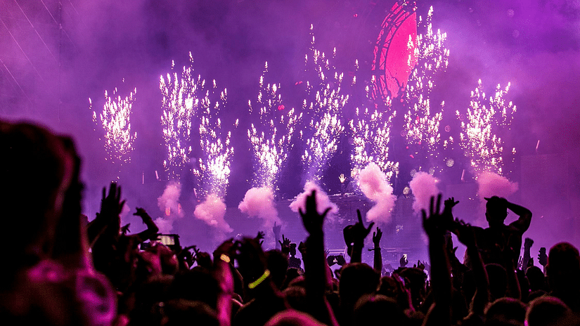 Image of fireworks and a group of people enjoying a party.