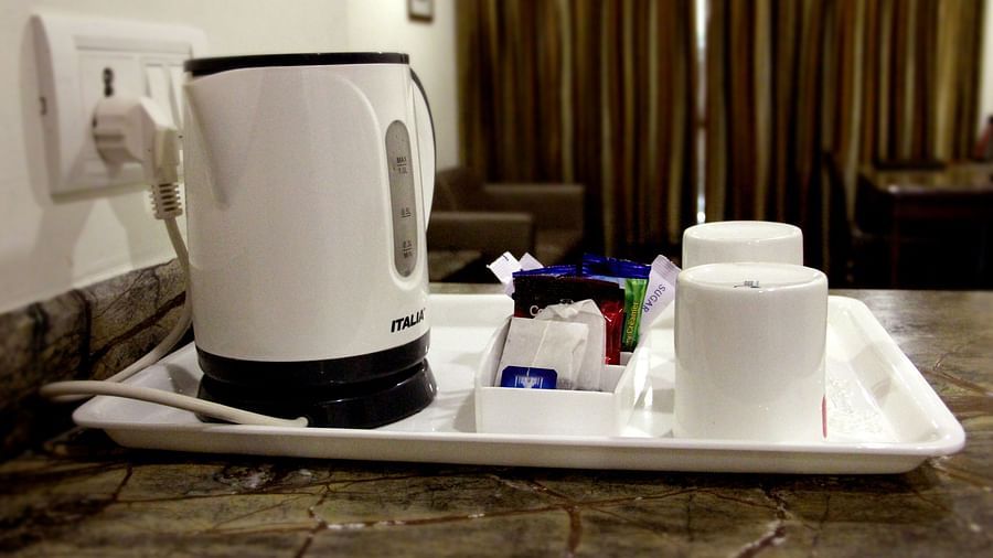 In-room tea and coffee setup with electric kettle and cups