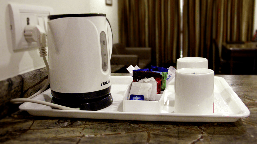 In-room tea and coffee setup with electric kettle and cups