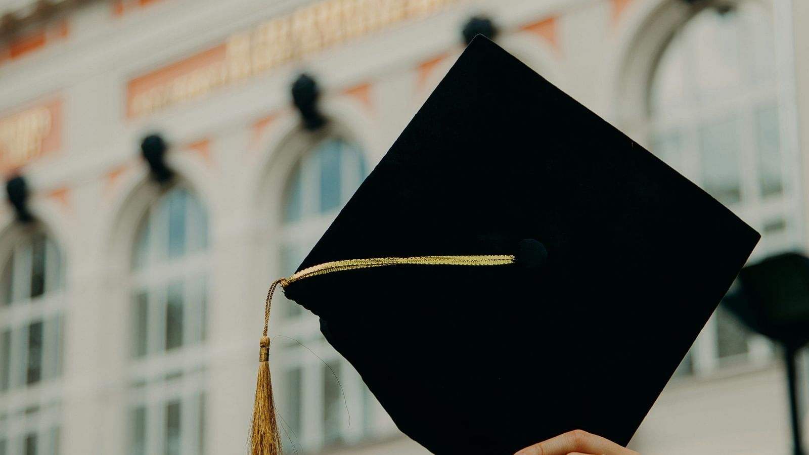 A person waving their graduation hat on air | Diamond Parks, Pune