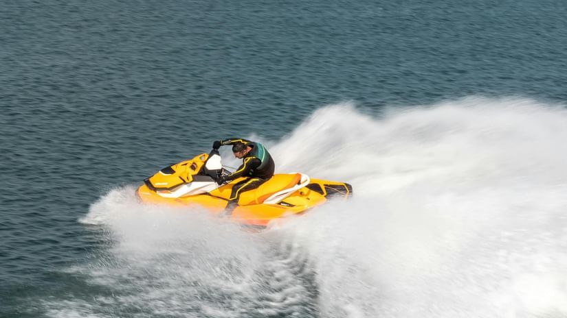 A person riding a jet ski on a clear, blue day