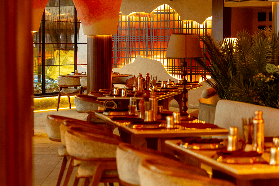 Indoor dining area at Jamun restaurant with seating and warm ceiling lighting - Symphony Resorts