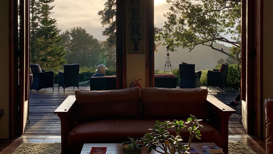A scenic view of the outdoors framed by large windows from the great room - Brewery Gulch Inn & Spa