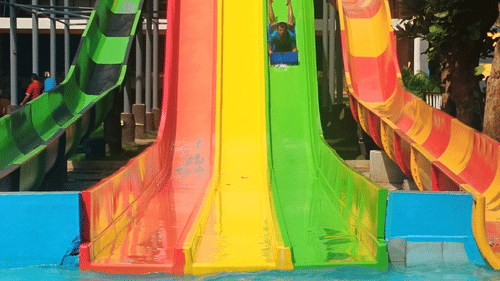 A vibrant, multicoloured water slide at Black Thunder Water Theme Park.