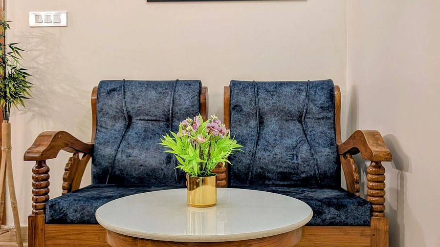 image of a common seating area at the pool side cottage featuring a blue coloured cushioned couch
