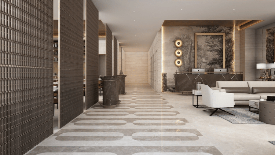 Interior corridor at Tulip Inn Bidar featuring decorative wall panels, tiled flooring, reception area, and lounge seating visible in background.