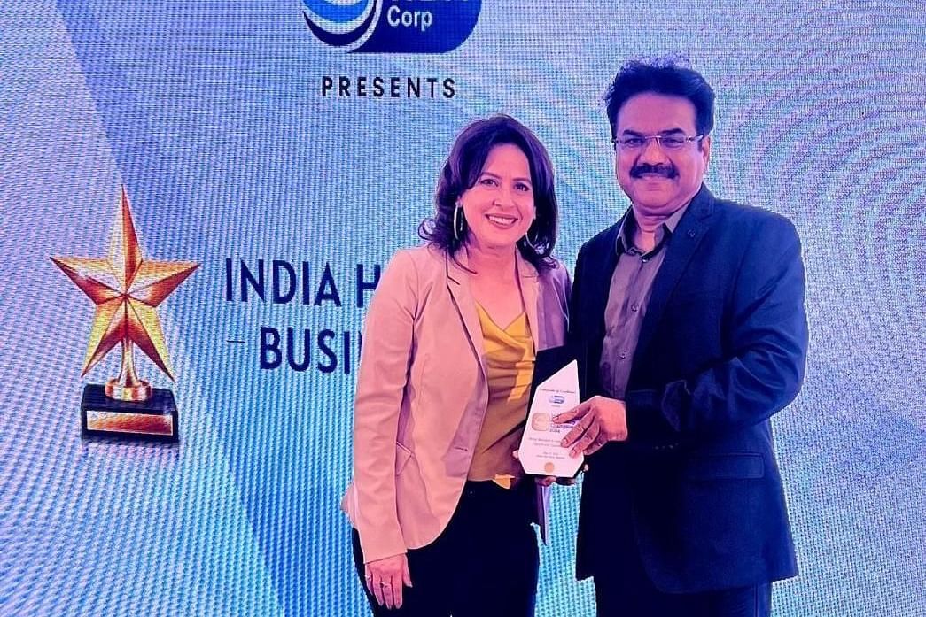 Image of a member of the resort receiving an award in an event  The Grand Legacy Resort and Spa