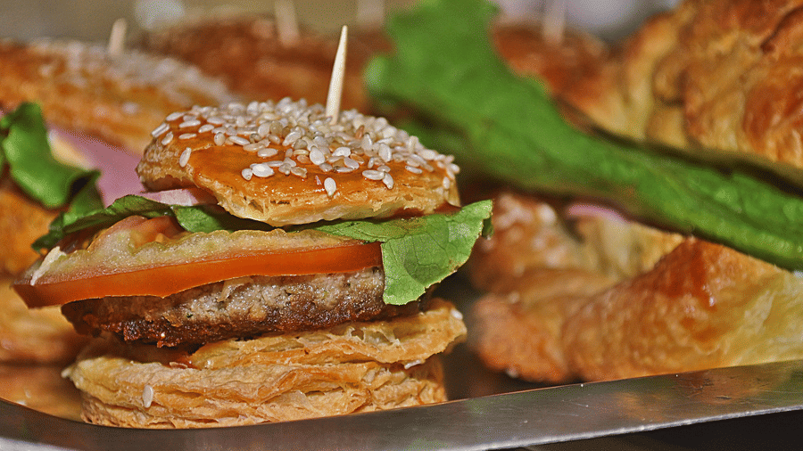 Woodstock Cafe featuring a shot of its burgers