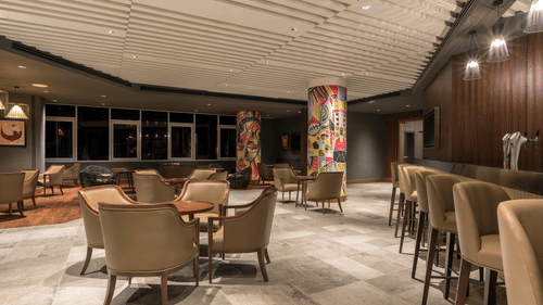 A modern and elegant design of Swirl Bar with warm lighting at Neelkanth Sarovar Premiere Lusaka