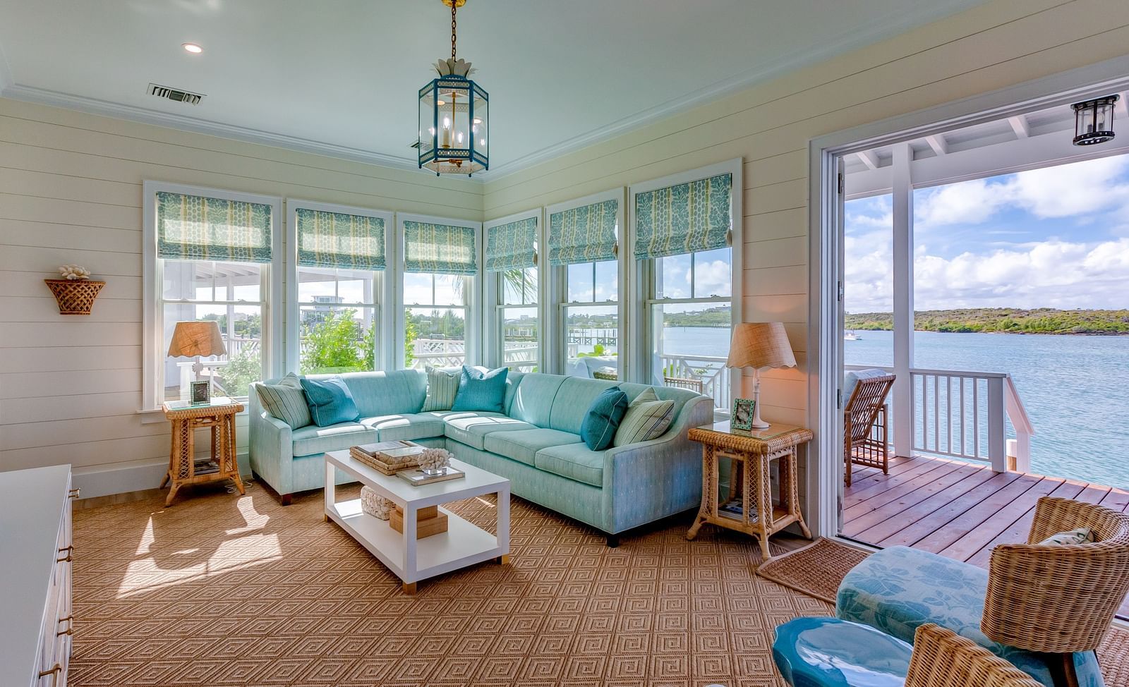 Lounge with plush seating, panoramic windows, and a chandelier | Abaco Inn