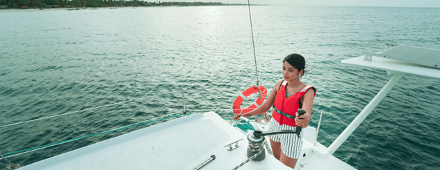 a girl sailing a yacht in a sea