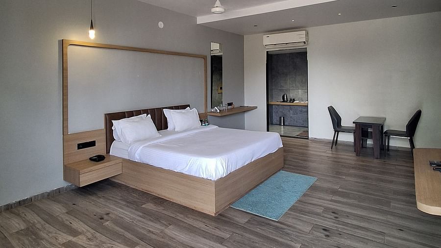 an image of side view of suite with a wall mounted television and a fan hanging from the ceiling at VITS Roccia Hill Resort & Adventure Park.