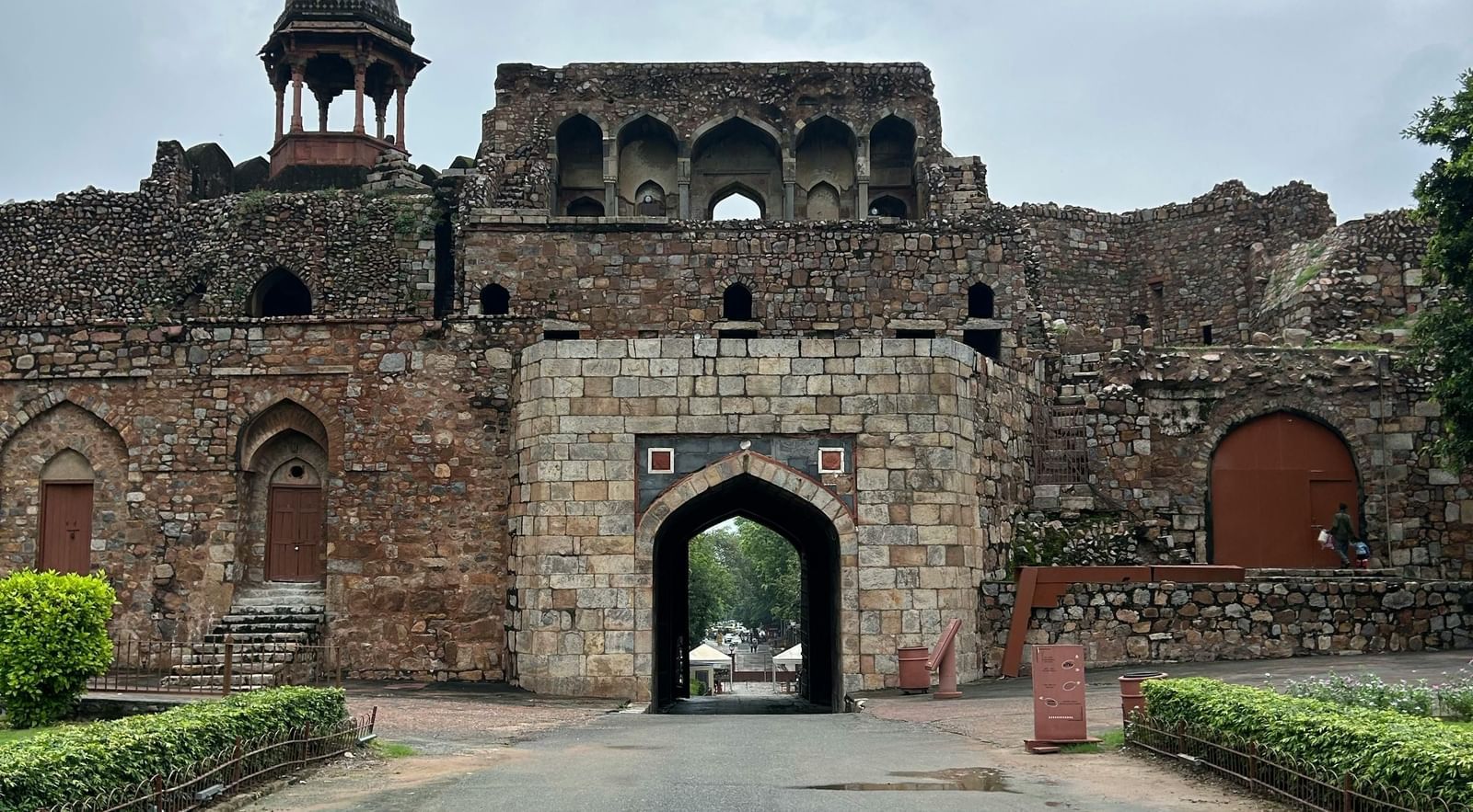 Exterior view of a fort with its grand entrance gate and surrounding pathway.