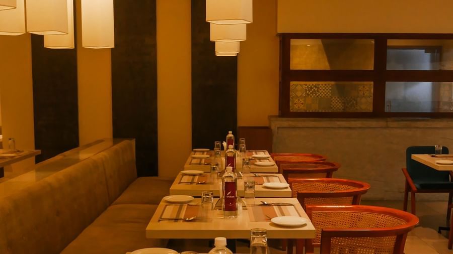 An inviting dining area with neatly set tables and warm pendant lighting, ready for guests at Shilton Dee Cee.