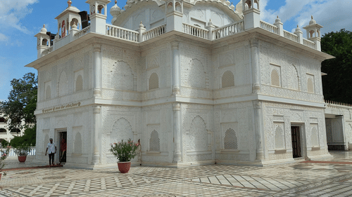 An image of a white building with a dome