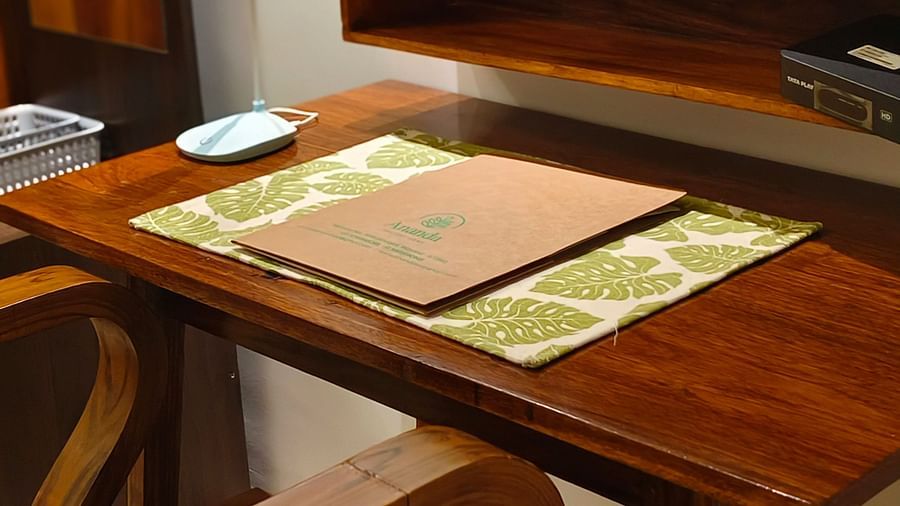 Close view of a study table and a chair in 101 non-ac room at Ananda Holiday Home, Wayanad 2