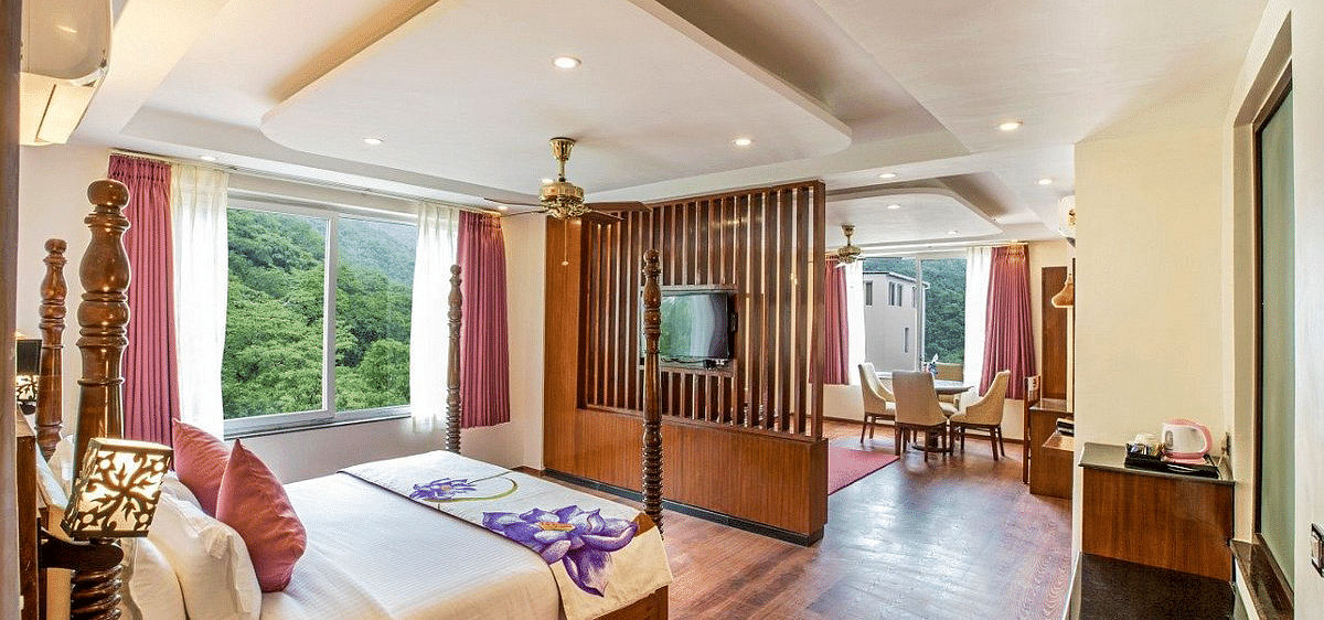 Corner view shot of the Suite with ample of natural light coming from the windows at Regenta Inn DLS.