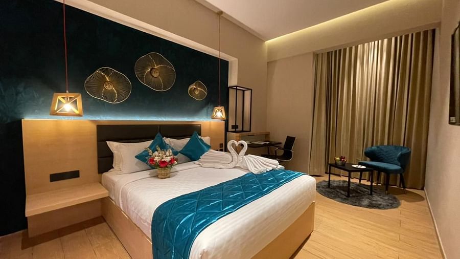 Double bed with blue sheets at Premium Room at Le Foliage by TGI, Bangalore