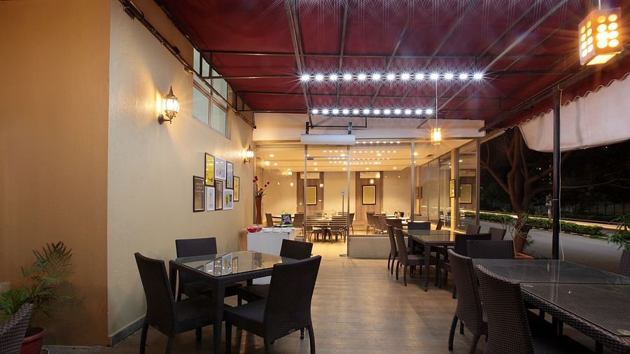 Seating arrangement in the restaurant at Starlit Suites, Bangalore
