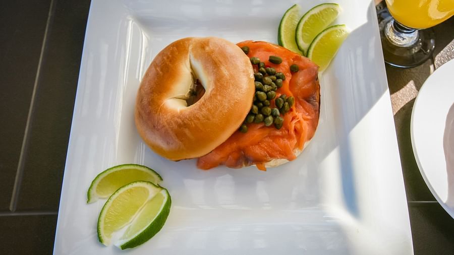 Close-up of bagel with lime wedges served on a plate | Abaco Inn