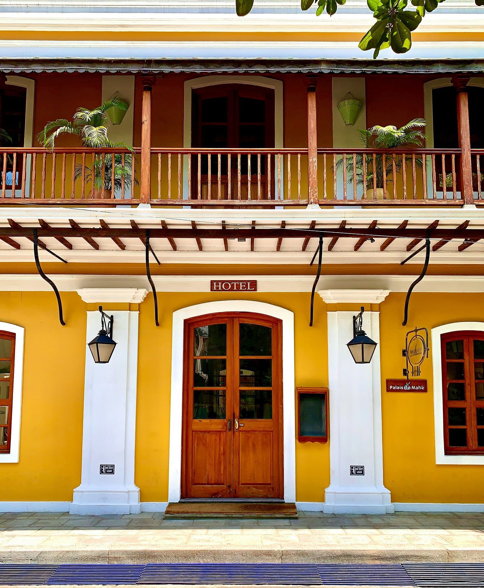 A charming and colourful facade of a colonial-style hotel