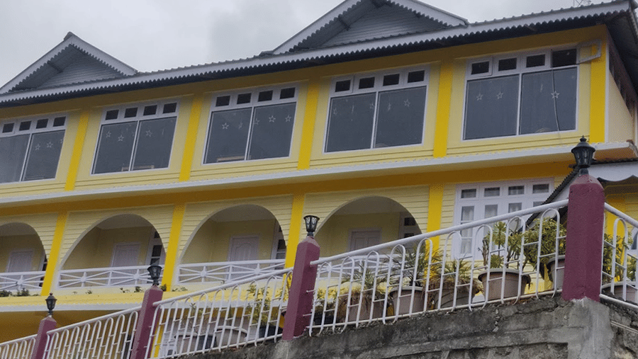 A facade of a building that has windows and veranda