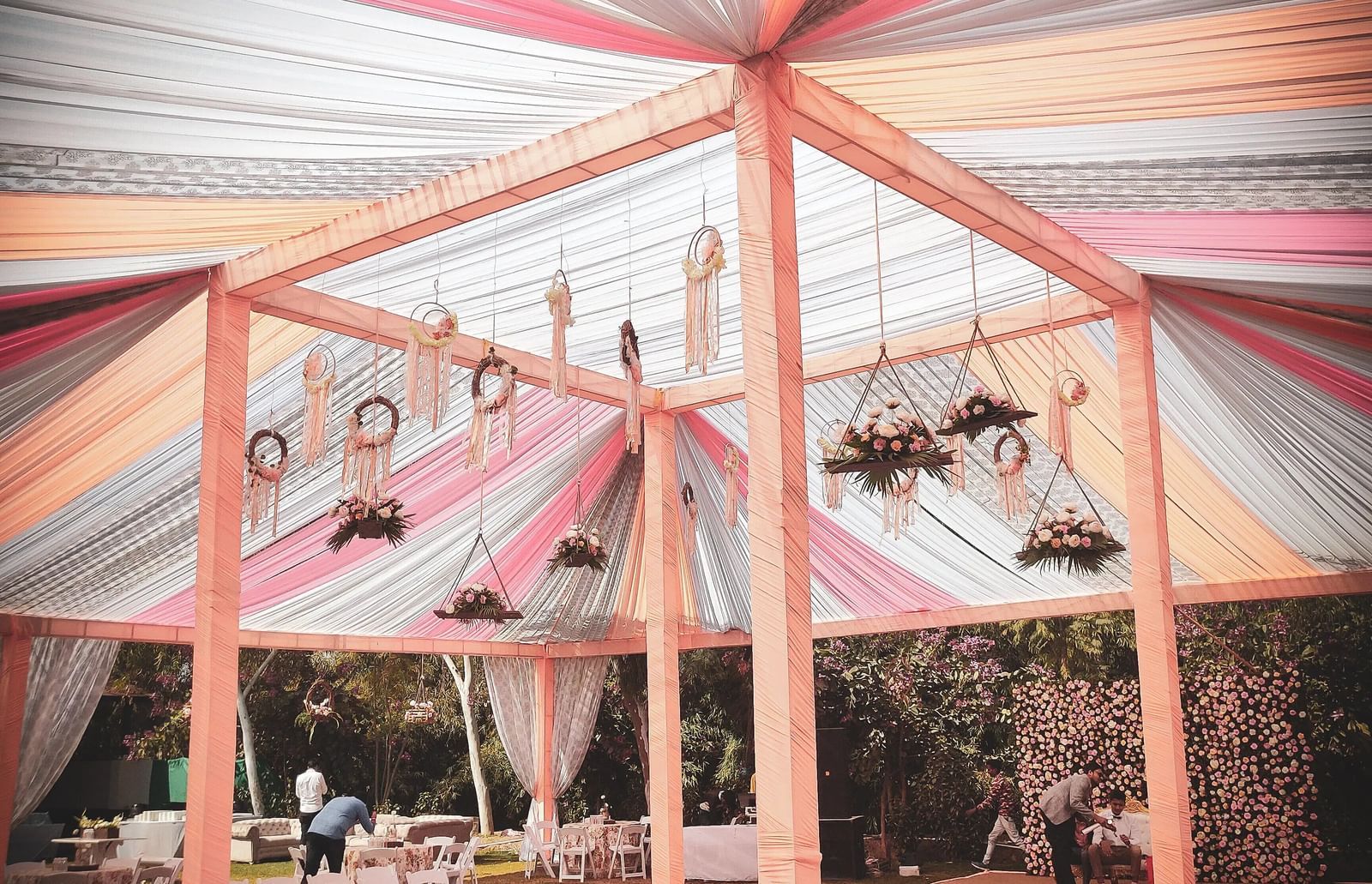 Outdoor event tent with colourful draped fabric ceiling, supported by a frame. - Bamboo Saa, Udaipur