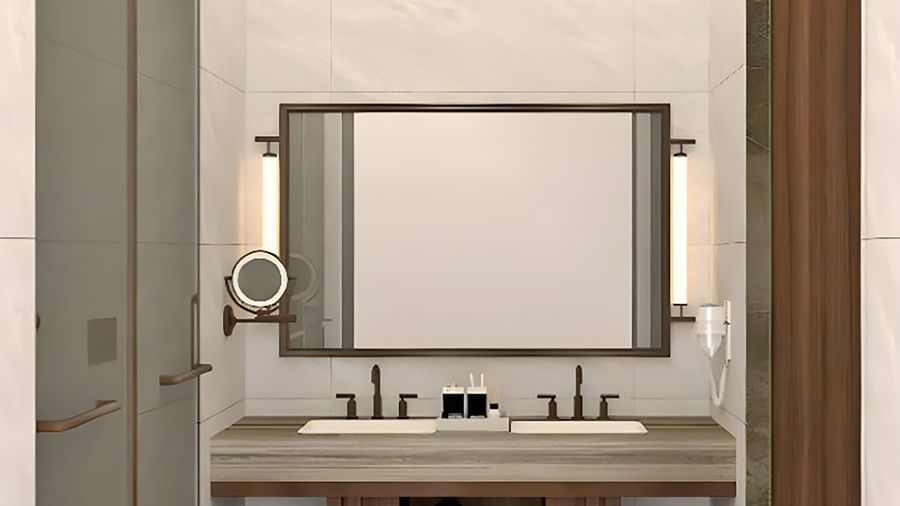 anctuary Suites bathroom at The Riverview Retreat, Corbett featuring wide mirror, twin sinks, and contemporary design.