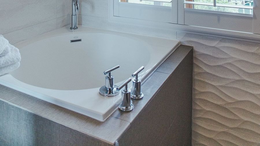 A bathroom with a soaking tub and natural light - Brewery Gulch Inn & Spa
