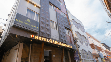 Exterior view of the multi-storey hotel building under a bright sky from a low angle - Perfectstayz Premium at Har Ki Pauri Road (Ganga Heights)