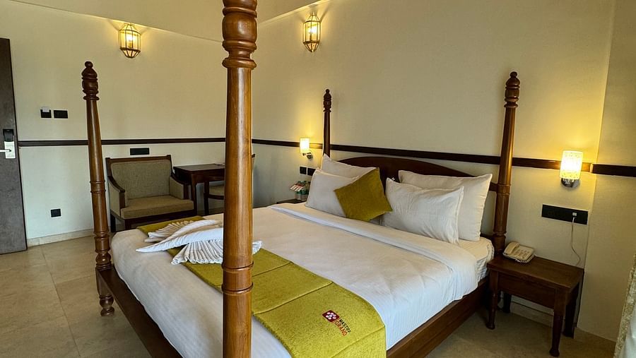 Poster cosy bed with a bed lamp in Studio Pool View Room at Mastiff Grand La Villae Resort, Lonavala