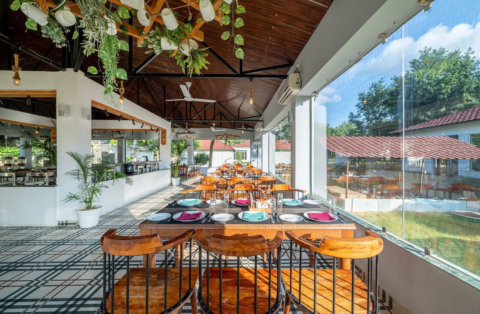 Back view of a dining area and ceiling decor featuring hanging plants and cups at Valley by Grassfield.  