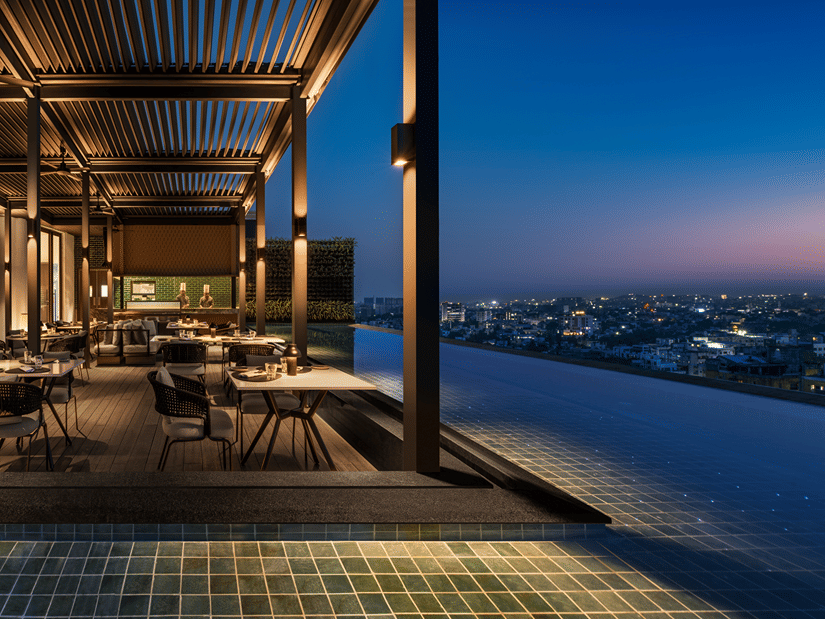 Rooftop Sky Dining at The Residency Towers Chennai, offering a stunning view after sunset, with a relaxed dining setting.