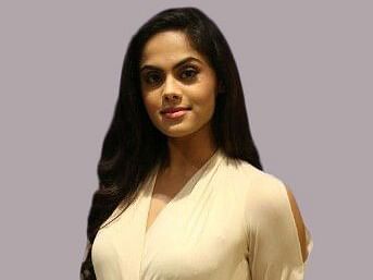 Karthika Nair, Director at UDS Group of Hotels in grey background