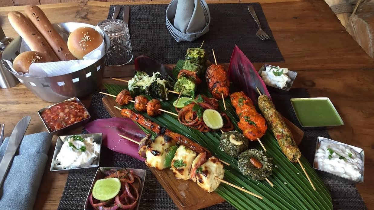 paneer tikka and chicken tikka served on a leaf platter