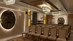 Conference seating setup at Presidium Sarovar Premiere, Dalhousie with chandeliers and wall decor.