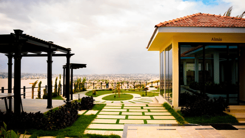 A scenic garden styled dining area featuring tiled pathways, pergola, and open sky backdrop - Serene Sarovar Premiere Hargeisa