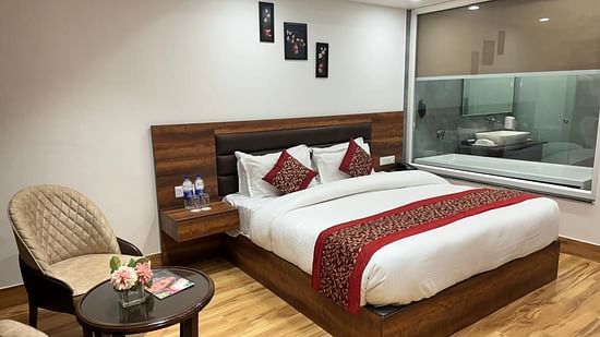 A modern hotel bedroom with a plush bed, stylish decor, and soft lighting creating a relaxing atmosphere - Clarks Inn Express, Near Jammu Bari Brahmana Railway Station