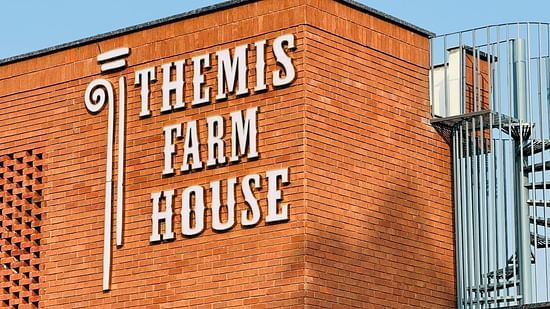 Image of the the themis farm house building with brown brick walls at Themis Mudhouse- A Nature's Wellness Resort