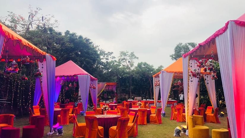 One of the open-air venues at Ananta spa & resort fully decked up with chairs, tables and a projector screen for events in pushkar 56