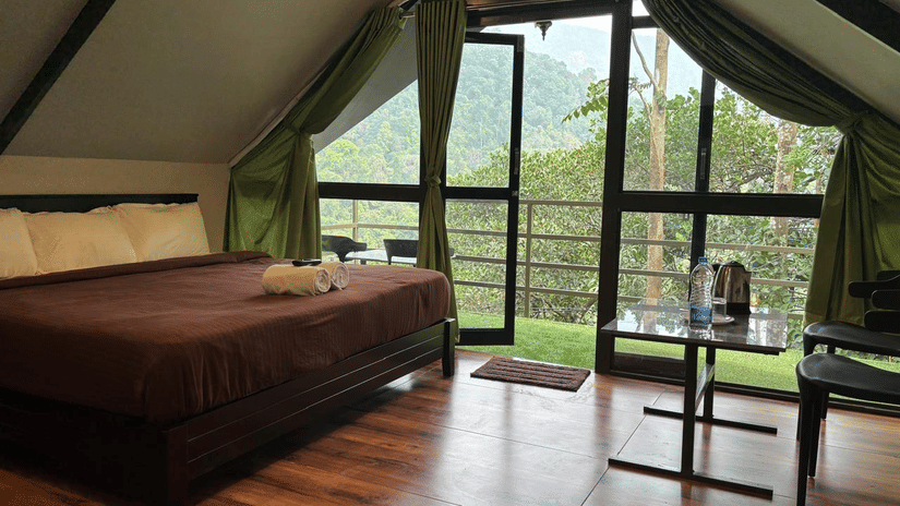Clean modern bathroom with white fixtures and grey concrete walls at Holistic Eco-Resort, Kannur.