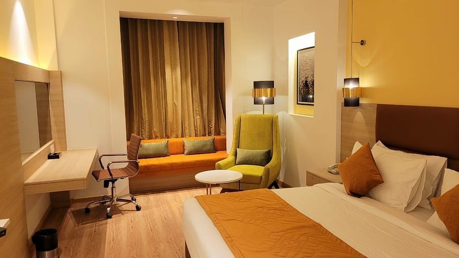 room with a king size bed and wooden flooring at best western vrindavan