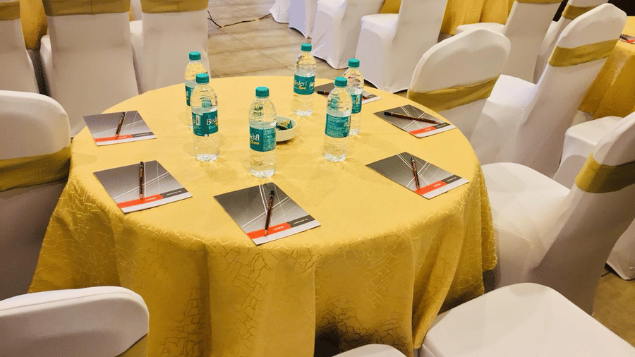 Image of a round table with chairs and stationary surrounding it at Amara Grand Baga, Goa.