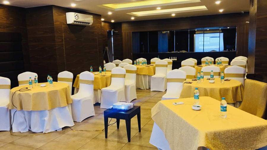 Image of a hall with cluster seating arrangement at Amara Grand Baga, Goa.