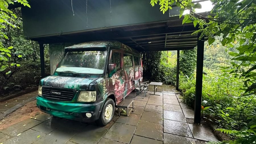 Illuminated elevator shaft surrounded by verdant forest canopy at Holistic Eco-Resort, Kannur.