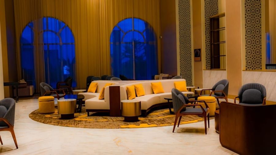 Wide-angle capture of lobby lounge with double sided sofas and warm lighting - Serene Sarovar Premiere Hargeisa
