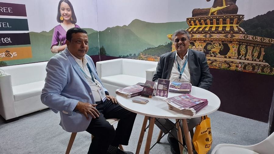 Representatives engaged in discussions at the Sumi Yashshree Hotels & Resorts booth, highlighting the brand's offerings of peace, comfort, and luxury.