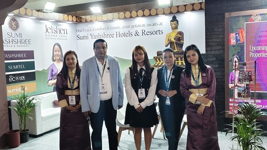 A distinguished team from Sumi Yashshree Hotels & Resorts poses at their well-designed exhibition booth, which highlights the brand's essence of peace, comfort, and luxury. 