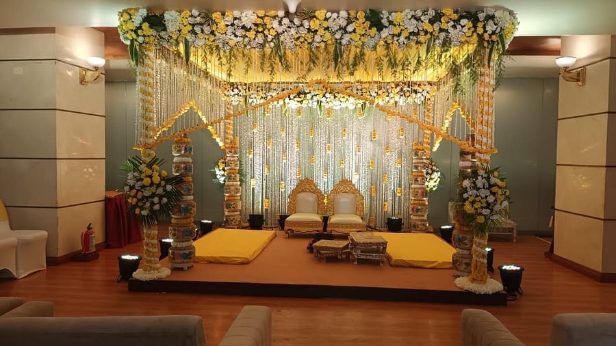 A beautifully decorated Haldi mandap adorned with vibrant flowers and twinkling lights at The Orchid Hotel Mumbai Vile Parle