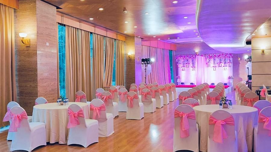 Indoor event space with pink chair sashes at The Orchid Hotel Mumbai Vile Parle